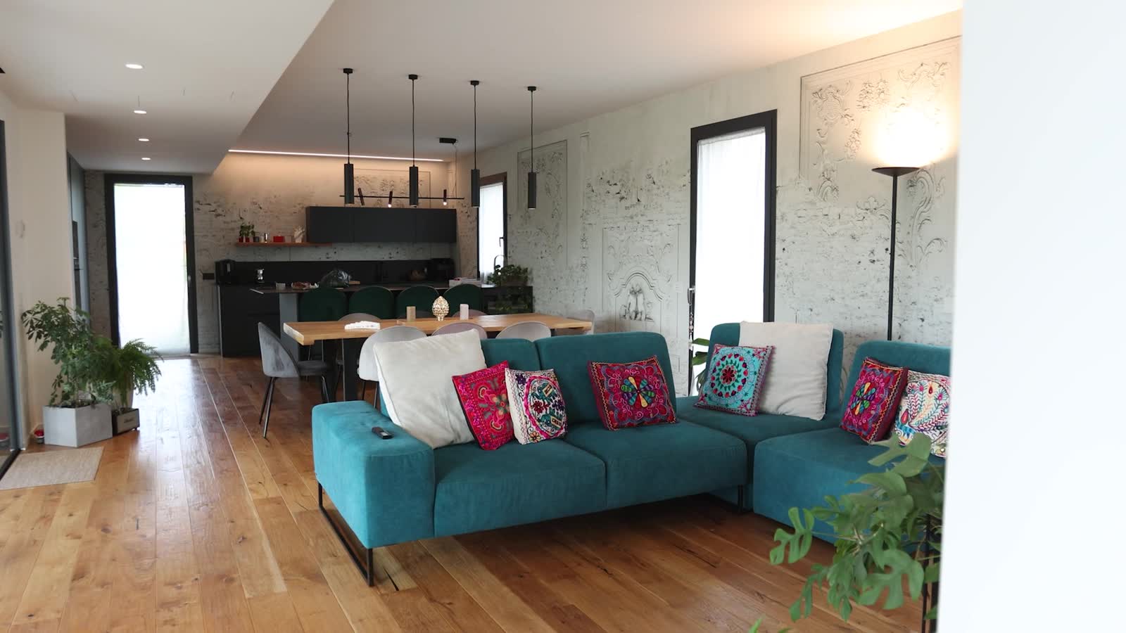 Zona giorno con cucina a vista e pavimento in legno